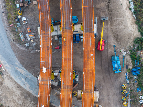 Aerial view of the Ringbahnbrucke bridge construction site at the Funkturm interchange with rusted steel girders yellow support pillars and heavy machinery in Berlin Berlin Germany. Aerial view of the Ringbahnbrucke bridge construction site at the Funkturm interchange with rusted steel girders yellow support pillars and heavy machinery in Berlin Berlin Germany.