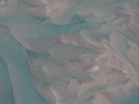 Aerial view of a braided river system with intricate sandbars and turquoise glacial meltwater flowing through the landscape in Skonseng Nordland Norway. Aerial view of a braided river system with intricate sandbars and turquoise glacial meltwater flowing through the landscape in Skonseng Nordland Norway.