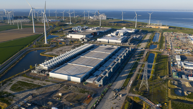 Aerial view of the Google Data Center surrounded by wind turbines and industrial infrastructure near the coast in Eemshaven Groningen Netherlands. Aerial view of the Google Data Center surrounded by wind turbines and industrial infrastructure near the coast in Eemshaven Groningen Netherlands.