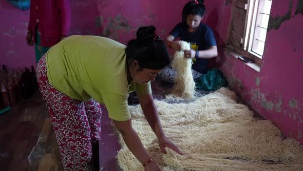 View of women preparing handmade noodles in Dhangadhi Nepal. View of women preparing handmade noodles in Dhangadhi Nepal.
