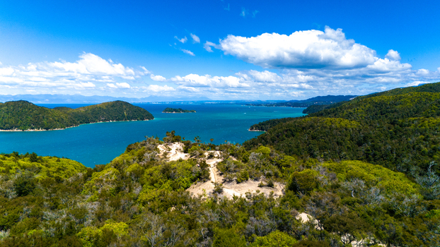 Aerial view of turquoise waters meeting verdant forests under a vast sky a paradise of contrasts Abel Tasman National Park Tasman Region New Zealand. Aerial view of turquoise waters meeting verdant forests under a vast sky a paradise of contrasts Abel Tasman National Park Tasman Region New Zealand.