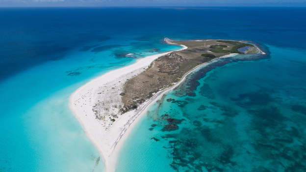 Aerial view of Los Roques archipelago featuring white sand beaches turquoise Caribbean waters and coral reefs in Los Roques Dependencias Federale Venezuela. Aerial view of Los Roques archipelago featuring white sand beaches turquoise Caribbean waters and coral reefs in Los Roques Dependencias Federale Venezuela.