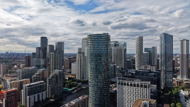 London United Kingdom 16 June 2026 Aerial view of the Canary Wharf financial district featuring modern skyscrapers and the One Park Drive tower under a cloudy sky.