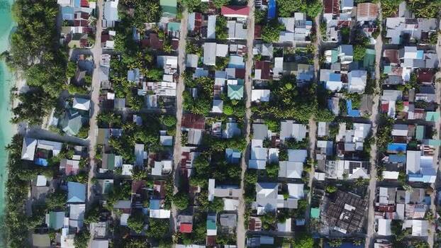 Aerial view of the dense residential grid and tropical greenery Maldives. Aerial view of the dense residential grid and tropical greenery Maldives.