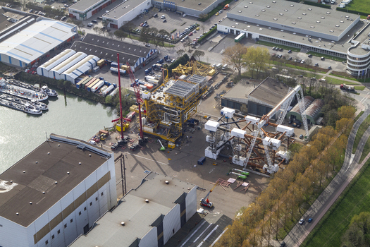 Aerial view of Rotterdam Harbour featuring industrial infrastructure large cranes and heavy machinery at the port facility in Rotterdam South Holland Netherlands. Aerial view of Rotterdam Harbour featuring industrial infrastructure large cranes and heavy machinery at the port facility in Rotterdam South Holland Netherlands.