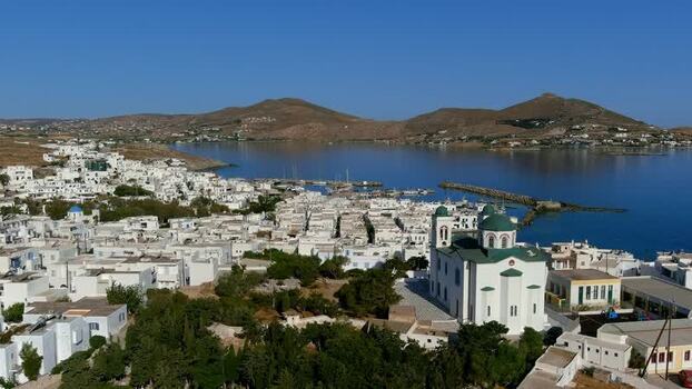 Aerial view of a coastal town with a white church in Greece. Aerial view of a coastal town with a white church in Greece.