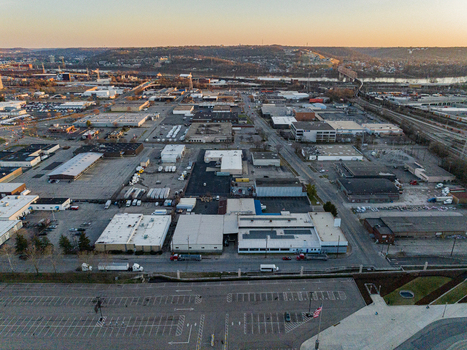 Aerial view of industrial buildings and parking lots stretching out towards the horizon with the river snaking through the landscape Cincinnati USA. Aerial view of industrial buildings and parking lots stretching out towards the horizon with the river snaking through the landscape Cincinnati USA.