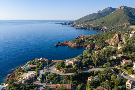 Aerial view of Le Trayas featuring coastal villas winding roads and lush Mediterranean vegetation overlooking the deep blue sea in Saint Raphael Provence Alpes Cote d Azur France. Aerial view of Le Trayas featuring coastal villas winding roads and lush Mediterranean vegetation overlooking the deep blue sea in Saint Raphael Provence Alpes Cote d Azur France.