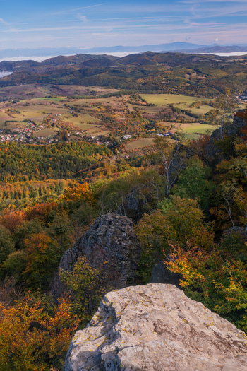 Aerial view of Sitno in Stiavnicke Vrchy with rocky outcrops and vibrant autumn forests overlooking the rural landscape of Ilija Banska Bystrica Region Slovakia.