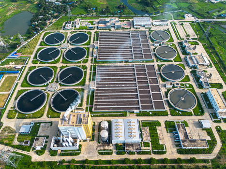Aerial view of the Sewage Treatment Plant Dhaka WASA featuring circular clarifiers and rectangular filtration basins surrounded by green fields in Dhaka Dhaka Division Bangladesh. Aerial view of the Sewage Treatment Plant Dhaka WASA featuring circular clarifiers and rectangular filtration basins surrounded by green fields in Dhaka Dhaka Division Bangladesh.