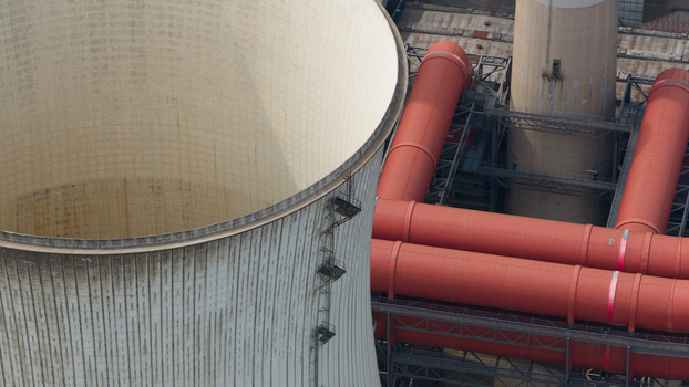 Aerial view of Kraftwerk Niederaussem with its large cooling tower and prominent red industrial pipes in Bergheim Nordrhein Westfalen Germany. Aerial view of Kraftwerk Niederaussem with its large cooling tower and prominent red industrial pipes in Bergheim Nordrhein Westfalen Germany.