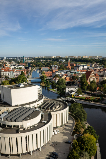Aerial view of the vibrant Opera Nova contrasting with the winding Brda river and the historic architecture Bydgoszcz Województwo kujawsko pomorskie Poland. Aerial view of the vibrant Opera Nova contrasting with the winding Brda river and the historic architecture Bydgoszcz Województwo kujawsko pomorskie Poland.