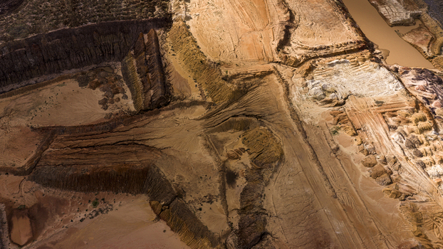 Aerial view of an industrial mining site showing intricate patterns of sand mineral deposits and excavated earth in Kalbarri Western Australia Australia. Aerial view of an industrial mining site showing intricate patterns of sand mineral deposits and excavated earth in Kalbarri Western Australia Australia.