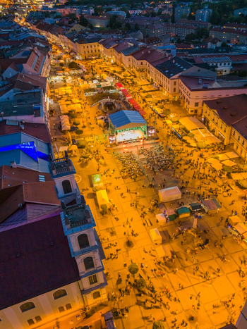 Aerial view of Radvansky jarmok traditional market illuminated at night with crowds of people browsing stalls in the historic town square of Banska Bystrica Banskobystricky kraj Slovakia.