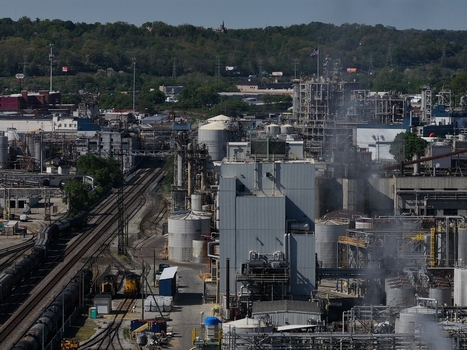 Aerial view of an industrial complex with storage tanks and railway tracks under a clear sky Cincinnati OH United States. Aerial view of an industrial complex with storage tanks and railway tracks under a clear sky Cincinnati OH United States.