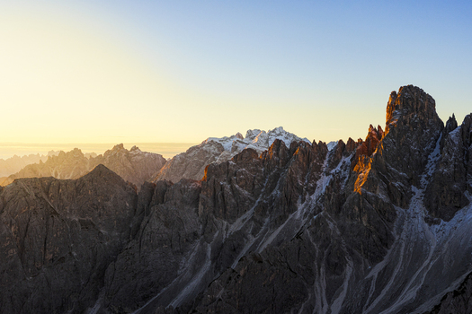 Aerial view of the Cadini di Misurina jagged Dolomitic peaks kissed by the golden light of dawn Auronzo di Cadore Veneto Italy. Aerial view of the Cadini di Misurina jagged Dolomitic peaks kissed by the golden light of dawn Auronzo di Cadore Veneto Italy.