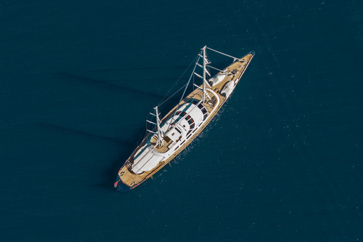 Aerial view of a large luxury sailing yacht cruising on the deep blue Mediterranean Sea Antibes Provence Alpes Cote d Azur France. Aerial view of a large luxury sailing yacht cruising on the deep blue Mediterranean Sea Antibes Provence Alpes Cote d Azur France.