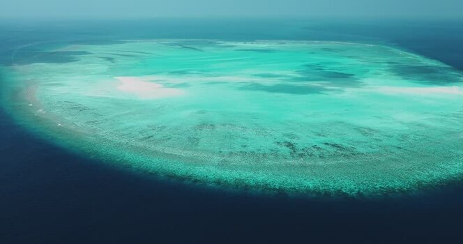 Aerial view of a coral reef atoll in the ocean Maldives. Aerial view of a coral reef atoll in the ocean Maldives.