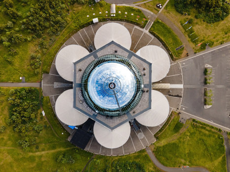 Aerial view of Perlan a landmark building with a glass dome and six large water tanks surrounded by green parkland in Reykjavik Reykjavikurborg Iceland. Aerial view of Perlan a landmark building with a glass dome and six large water tanks surrounded by green parkland in Reykjavik Reykjavikurborg Iceland.