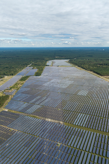 Aerial view of the solar field at the former military airfield in Preschen with rows of photovoltaic panels across the historic runway and taxiway in Neisse Malxetal Brandenburg Germany. Aerial view of the solar field at the former military airfield in Preschen with rows of photovoltaic panels across the historic runway and taxiway in Neisse Malxetal Brandenburg Germany.