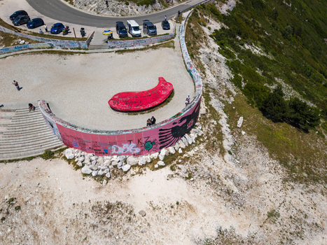 Himare Albania 12 June 2026 Aerial view of the Panorama Llogora viewpoint with its graffiti covered wall red sculpture and tourists on the Llogara Pass mountain road.