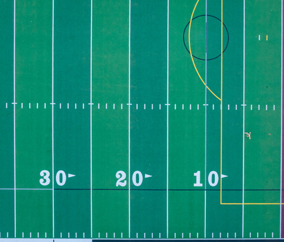 Aerial view of an American football field with yard line markings and hash marks on the green turf in Las Vegas Nevada United States. Aerial view of an American football field with yard line markings and hash marks on the green turf in Las Vegas Nevada United States.