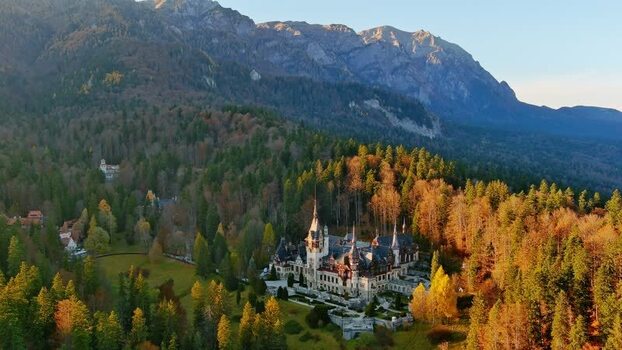 Aerial view of Peles Castle in autumn forest Romania. Aerial view of Peles Castle in autumn forest Romania.