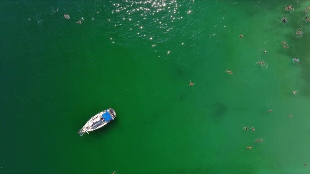 Aerial view of a boat in the green waters of Thasos Greece. Aerial view of a boat in the green waters of Thasos Greece.