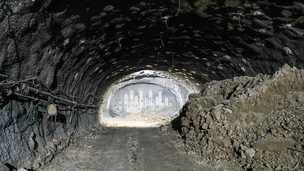 View of an underground tunnel under construction with rough rock walls and electrical wiring Istanbul Istanbul Turkey. View of an underground tunnel under construction with rough rock walls and electrical wiring Istanbul Istanbul Turkey.