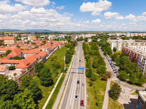 Aerial view of the historic city center with red rooftops modern residential buildings and a main road under a cloudy blue sky Trnava Trnava Region Slovakia. Aerial view of the historic city center with red rooftops modern residential buildings and a main road under a cloudy blue sky Trnava Trnava Region Slovakia.