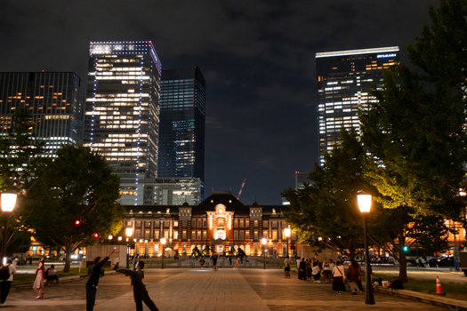 Tokyo Japan 30 September 2025 View of the illuminated Tokyo Station nestled amidst modern skyscrapers with people enjoying the evening in the softly lit plaza. Tokyo Japan 30 September 2025 View of the illuminated Tokyo Station nestled amidst modern skyscrapers with people enjoying the evening in the softly lit plaza.