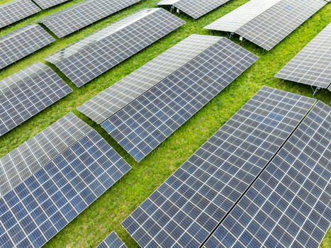 Aerial view of rows of solar panels in a photovoltaic power plant on green grass Aiglsbach Bavaria Germany.