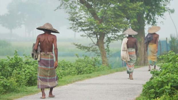 View of men walking on a rural road in Bogura Bangladesh.