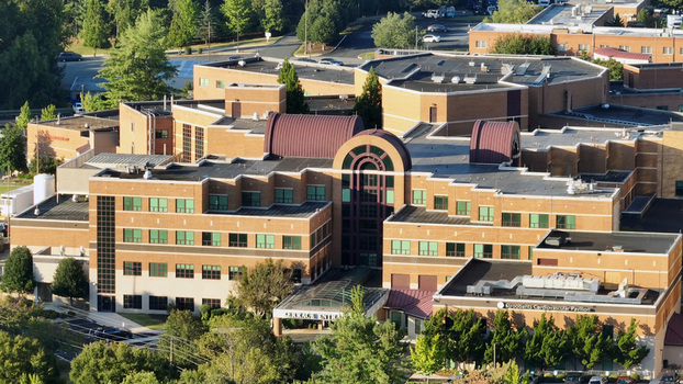 Aerial view of the Centra Lynchburg General Hospital complex with its distinctive brick facade arched entrance and surrounding parking areas in Lynchburg Virginia United States. Aerial view of the Centra Lynchburg General Hospital complex with its distinctive brick facade arched entrance and surrounding parking areas in Lynchburg Virginia United States.