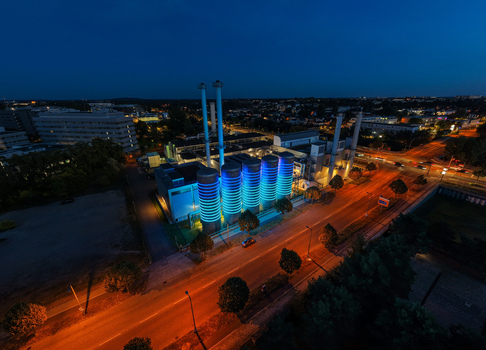 Aerial view of the BTB Heat and Power Plant Adlershof at night with glowing tanks visualizing heat energy storage in the urban landscape of Berlin Berlin Germany. Aerial view of the BTB Heat and Power Plant Adlershof at night with glowing tanks visualizing heat energy storage in the urban landscape of Berlin Berlin Germany.