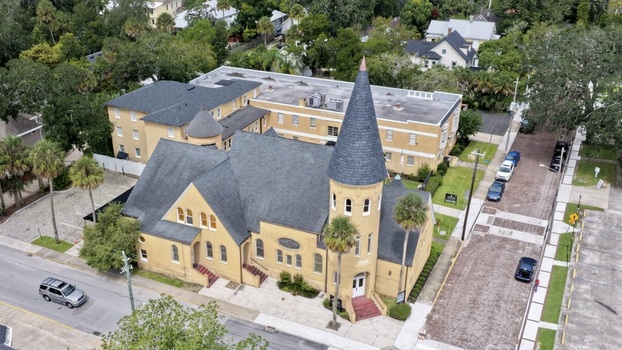 Aerial view of the historic Ancient City Baptist Church with its distinctive steeple surrounded by lush palm trees and urban streets in St. Augustine Florida United States. Aerial view of the historic Ancient City Baptist Church with its distinctive steeple surrounded by lush palm trees and urban streets in St. Augustine Florida United States.
