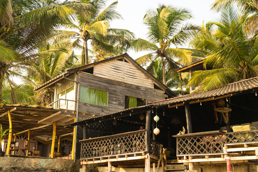 View of a rustic wooden beach house nestled among tropical palm trees in Galle Southern Province Sri Lanka.