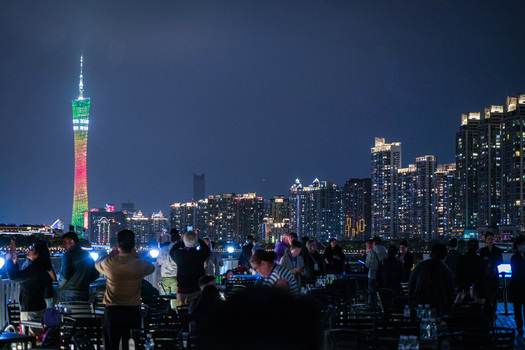 Guangzhou China 22 February 2024 View of Canton Tower illuminated at night with a crowd of people enjoying the city skyline from a terrace. Guangzhou China 22 February 2024 View of Canton Tower illuminated at night with a crowd of people enjoying the city skyline from a terrace.