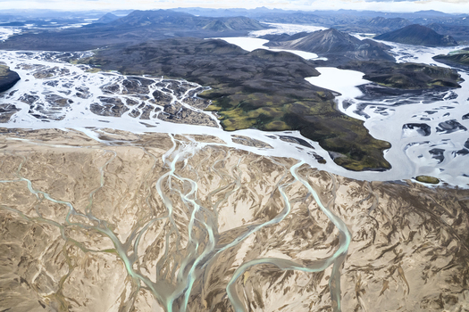 Aerial view of the intricate braided glacial rivers and volcanic mountains along the F208 road in the Icelandic Highlands Iceland. Aerial view of the intricate braided glacial rivers and volcanic mountains along the F208 road in the Icelandic Highlands Iceland.
