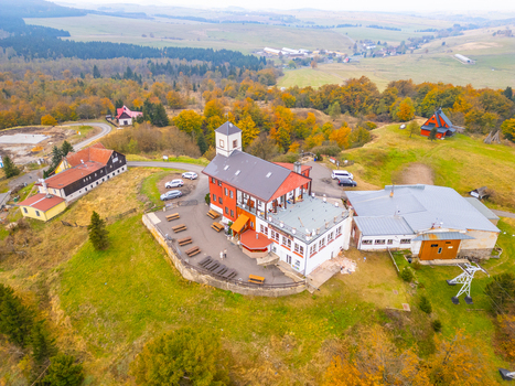 Aerial view of the Komari vizka mountain restaurant and upper station surrounded by autumn forests and rolling hills in Krupka Usti nad Labem Region Czechia. Aerial view of the Komari vizka mountain restaurant and upper station surrounded by autumn forests and rolling hills in Krupka Usti nad Labem Region Czechia.