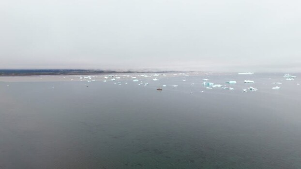 Aerial view of icebergs floating in Disko Bay Greenland. Aerial view of icebergs floating in Disko Bay Greenland.