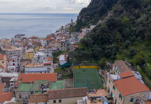Aerial view of terracotta rooftops cascading down to the azure sea nestled against a verdant cliffside Amalfi Campania Italy. Aerial view of terracotta rooftops cascading down to the azure sea nestled against a verdant cliffside Amalfi Campania Italy.