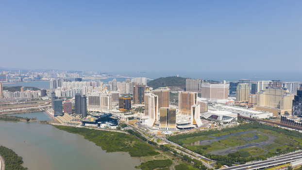 Macao 18 February 2026 Aerial view of the Cotai Strip featuring modern luxury hotel towers casinos and urban infrastructure surrounded by coastal wetlands and the sea under a clear sky. Macao 18 February 2026 Aerial view of the Cotai Strip featuring modern luxury hotel towers casinos and urban infrastructure surrounded by coastal wetlands and the sea under a clear sky.