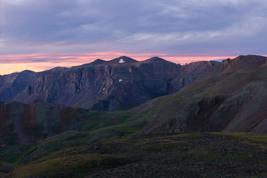 Aerial view of Mount Sneffels in the San Juan Mountains at sunset with the rugged peaks of Yankee Boy Basin and rocky terrain in Ouray Colorado United States. Aerial view of Mount Sneffels in the San Juan Mountains at sunset with the rugged peaks of Yankee Boy Basin and rocky terrain in Ouray Colorado United States.
