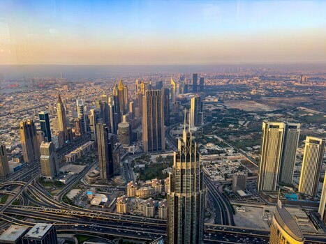 Aerial view of the modern Dubai skyline featuring towering skyscrapers complex highway interchanges and urban infrastructure under a clear sky in Dubai Dubai United Arab Emirates. Aerial view of the modern Dubai skyline featuring towering skyscrapers complex highway interchanges and urban infrastructure under a clear sky in Dubai Dubai United Arab Emirates.
