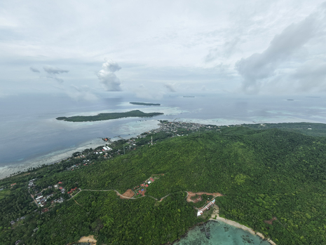 Aerial view of the island s lush green landscape meeting the turquoise waters under a vast sky Karimunjawa Central Java Indonesia.