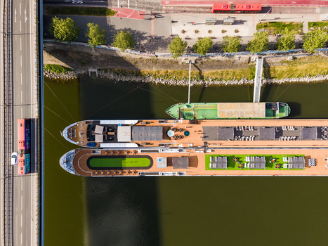 Aerial view of river cruise ships docked along the Danube riverbank next to a bridge in Bratislava Bratislava Region Slovakia. Aerial view of river cruise ships docked along the Danube riverbank next to a bridge in Bratislava Bratislava Region Slovakia.
