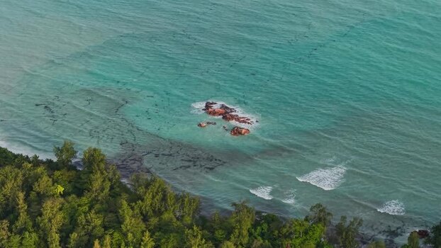 Aerial view of turquoise waters and rocky outcrop Seychelles.