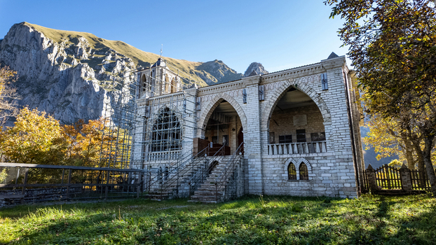 View of Eremo di San Leonardo al Volubrio with its stone facade and gothic arches under restoration against the Sibillini Mountains Rubbiano Marche Italy.