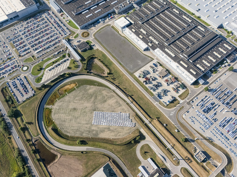 Aerial view of the Volkswagen plant near Devinska Nova Ves featuring large industrial buildings extensive parking lots and a test track in Bratislava Bratislavsky kraj Slovakia. Aerial view of the Volkswagen plant near Devinska Nova Ves featuring large industrial buildings extensive parking lots and a test track in Bratislava Bratislavsky kraj Slovakia.